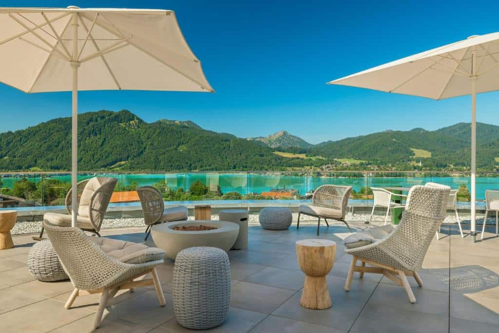 Terrasse des Caro & Selig mit diversen Sitzgelegenheiten und Blick auf den Tegernsee und das gegenüberliegende Ufer